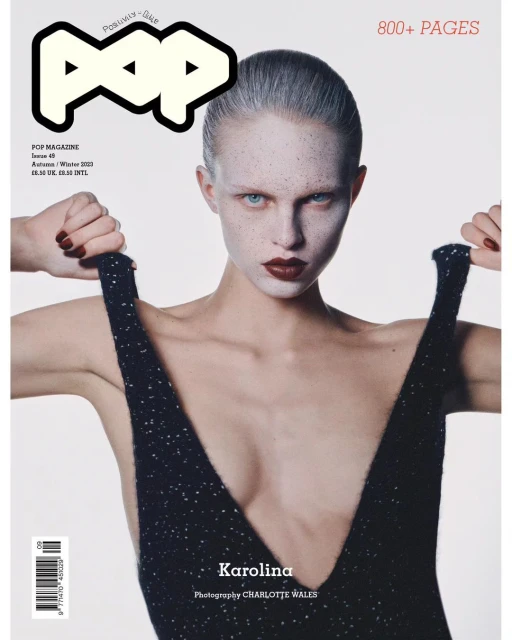 Pop magazine cover featuring a fair-skinned woman with dark lipstick wearing a black dress, gazing intently at the camera.