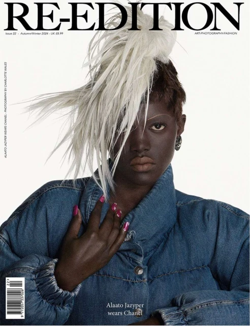 Re-Edition magazine cover featuring Alaato Jazyper wearing Chanel and a feathered hat, set against a bright background in a studio setting.