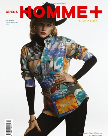 Model wearing a black cowboy hat, gold hoop earrings, and a patterned Moschino button-up shirt against a white seamless background.