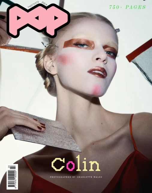 Pop Magazine cover features a blond model with bright makeup wearing a red dress, holding a silver object against a white background.