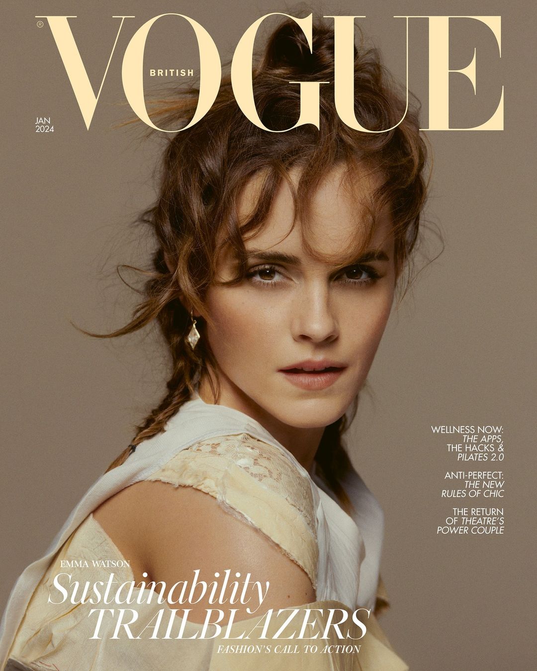 Emma Watson on British Vogue cover, January 2024. Brunette poses in lace-trimmed dress, natural makeup, hair in braided updo, diamond earrings.