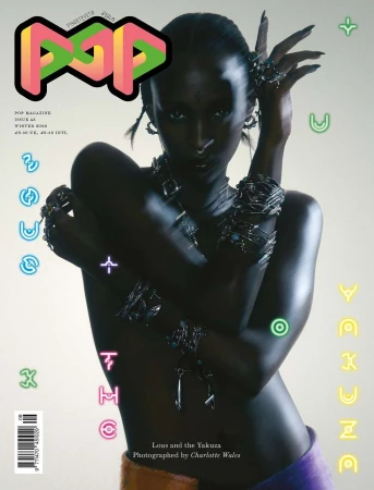 Magazine cover featuring an adult female model with dark skin wearing jewelry and fashionable clothing against a light background.
