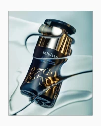Intuisse skincare cream bottle surrounded by fluid motion on a pale grey background photographed by Chelsea Kyle