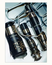 Three black skincare bottles arranged on a reflective liquid metallic chrome surface