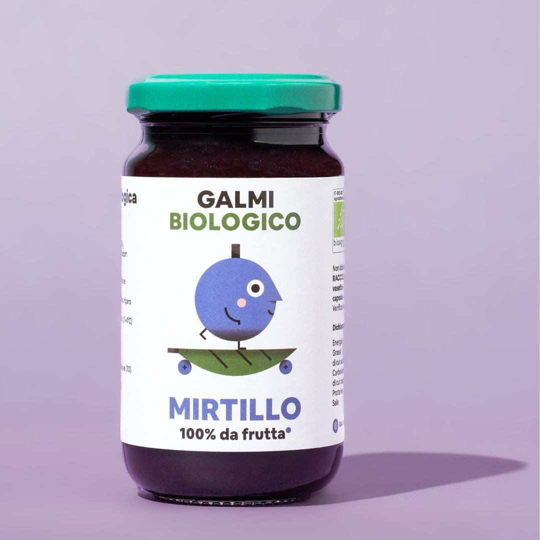 A jar of Galmi Biologico blueberry fruit spread with a cartoon blueberry character on the label, set against a solid lavender background.