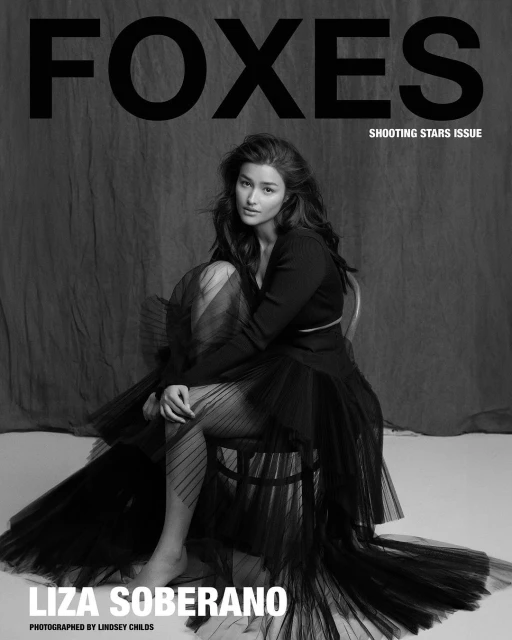 Liza Soberano sits in a black tulle dress for a magazine cover, black and white photography, indoor setting with draped backdrop.