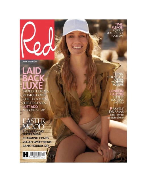 Magazine cover featuring a smiling woman in a cap and casual attire, with the magazine title 'Red' prominently displayed in red.