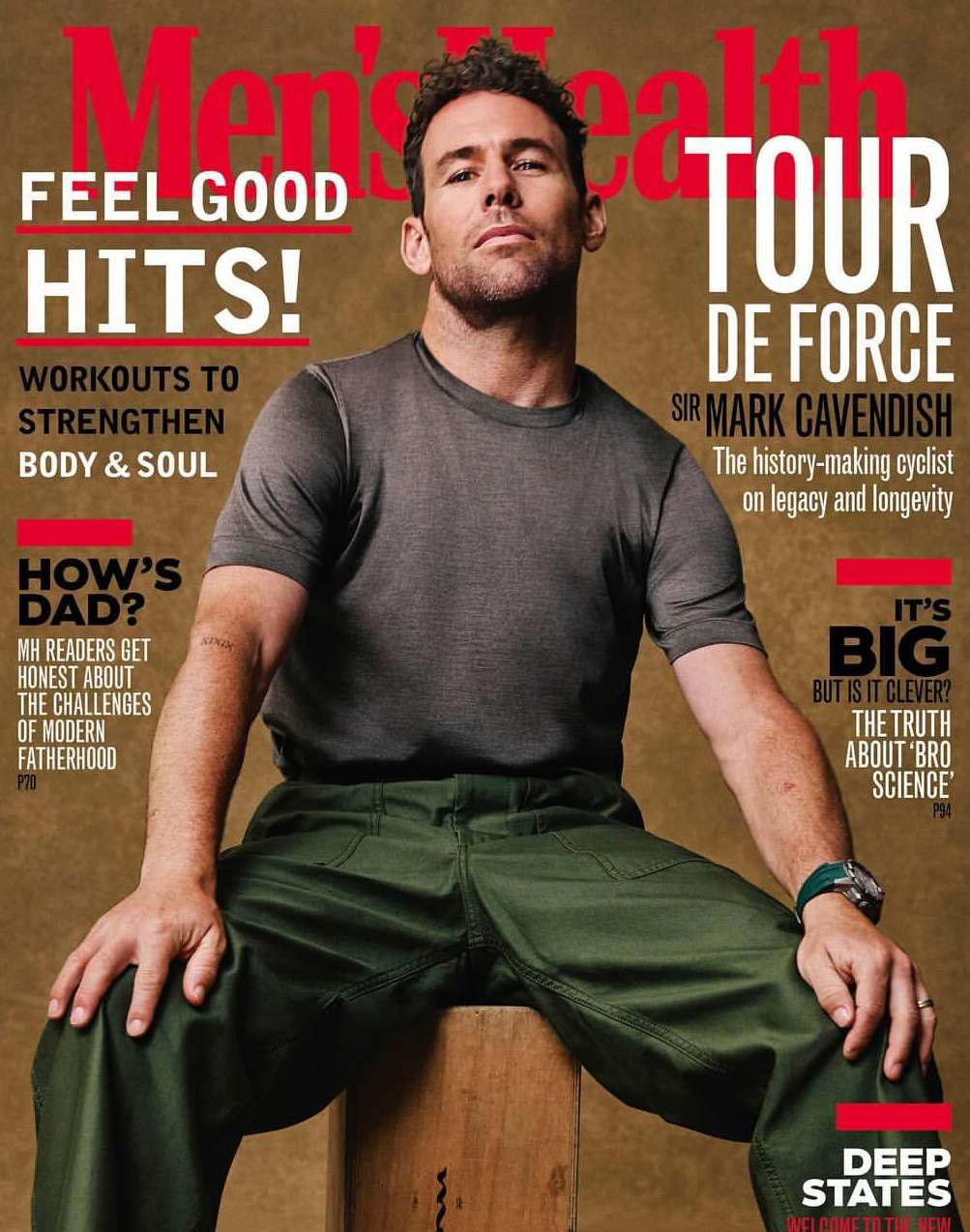 Men's Health magazine cover featuring a man in gray t-shirt and green pants sitting on a wooden box against a tan background.