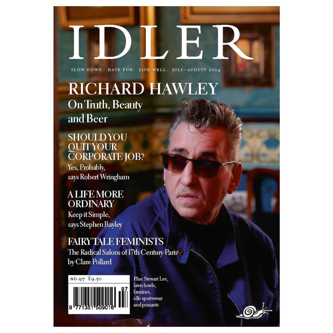 Magazine cover featuring Richard Hawley, promoting slow living and culture; photographed indoors with dark, rich colors and shallow focus.