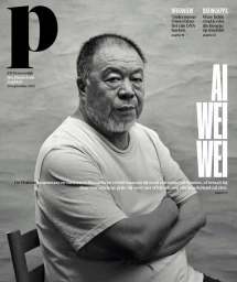 Portrait of Ai Weiwei with arms crossed seated against a textured grey background