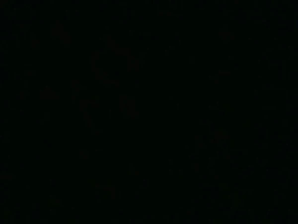 Monochromatic black background with no visible details, creating a stark and minimal visual impression.