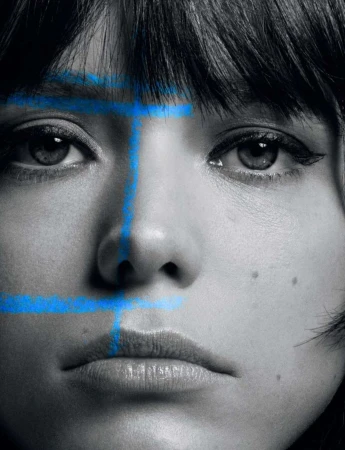 Portrait of a woman with blue painted lines on her face, creating a striking visual effect in a black and white photograph, close-up.