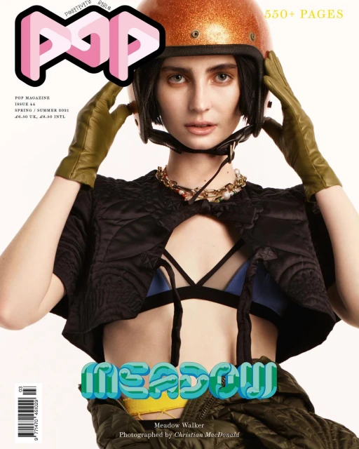 Magazine cover featuring Meadow Walker in an orange helmet, olive gloves, and black jacket with the 'POP' logo and 'MEADOW' text.