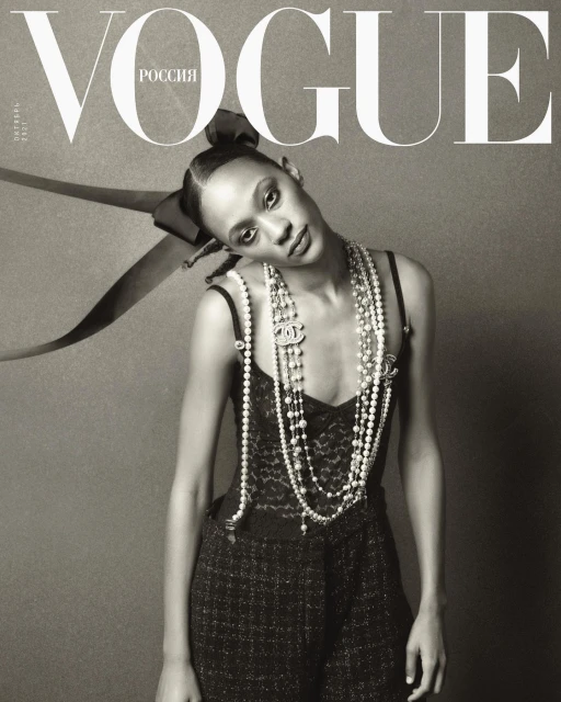 Vogue Russia cover featuring a woman with pearl necklaces and a bow, captured in black and white with high fashion elements.
