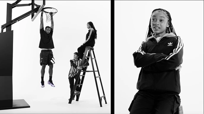 Black-and-white studio shot of four people in sports apparel, including a basketball player hanging from a net, and a girl in a tracksuit.