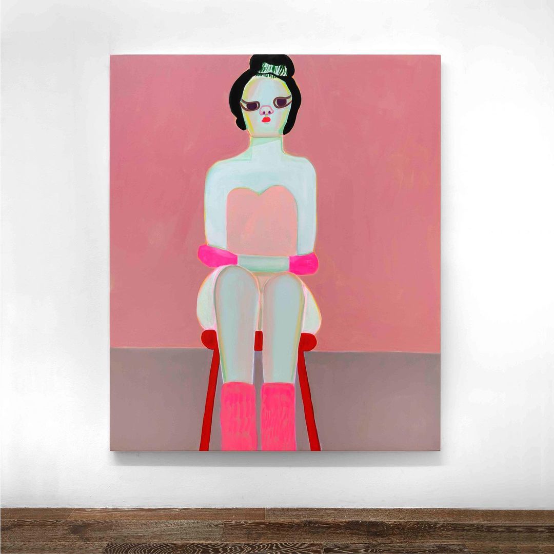 An illustration shows a pale woman with black hair and pink accents, seated on a red stool against a pink and grey background.
