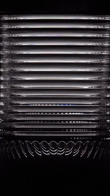Abstract pattern of dark horizontal lines with white borders and half-circle shapes at the bottom against a dark background.