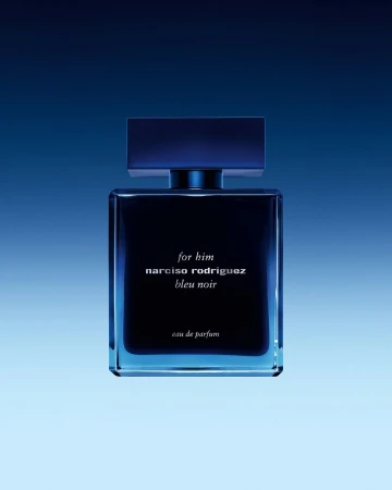 Square, blue bottle of Narciso Rodriguez Bleu Noir eau de parfum against a gradient blue background in a studio product shot.