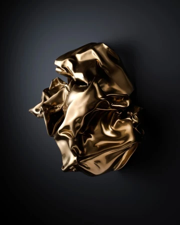 Abstract photo of a gold metallic-colored crumpled fabric sculpture against a dark background, reflecting studio lighting.