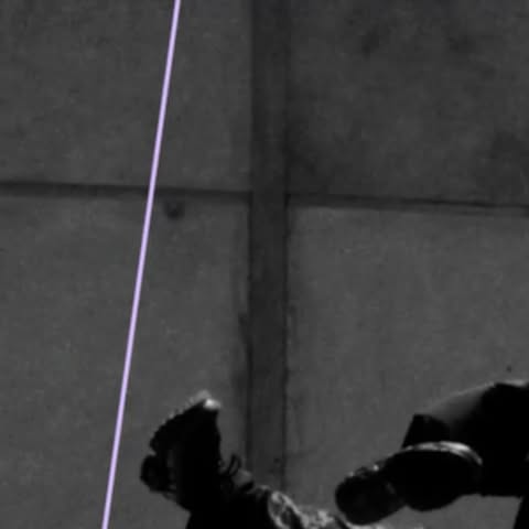 Monochromatic shot of an adult and child in darkness, embracing, with feet and lower bodies primarily visible.