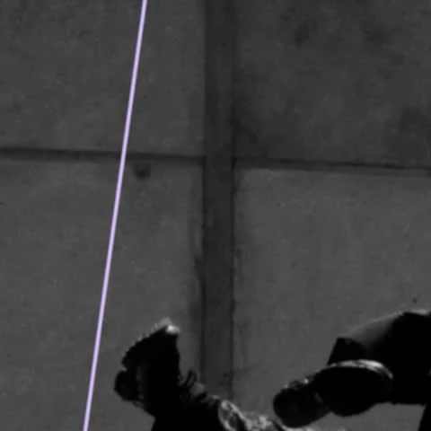 Monochromatic shot of an adult and child in darkness, embracing, with feet and lower bodies primarily visible.