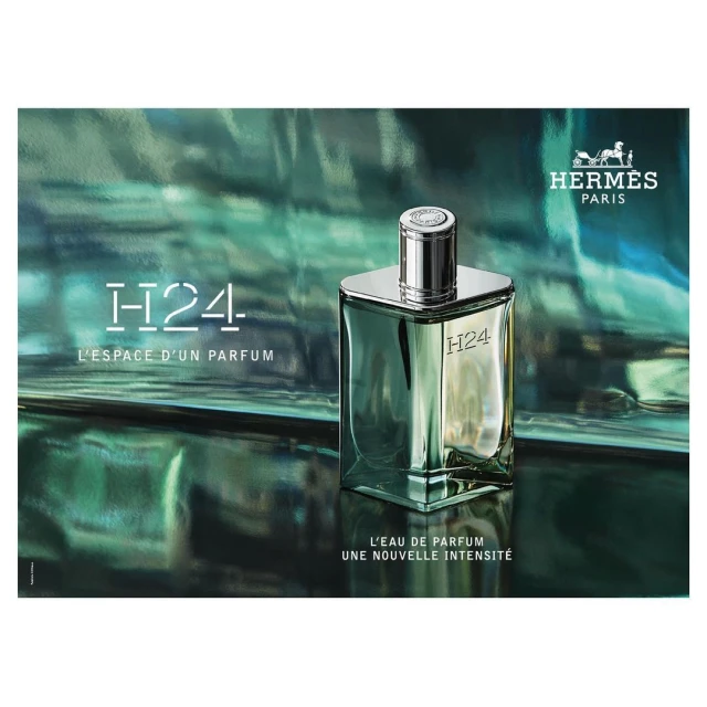 Elegant studio shot of Hermès H24 Eau de Parfum in a clear glass bottle, featuring the brand logo and product name against a shimmering green backdrop.