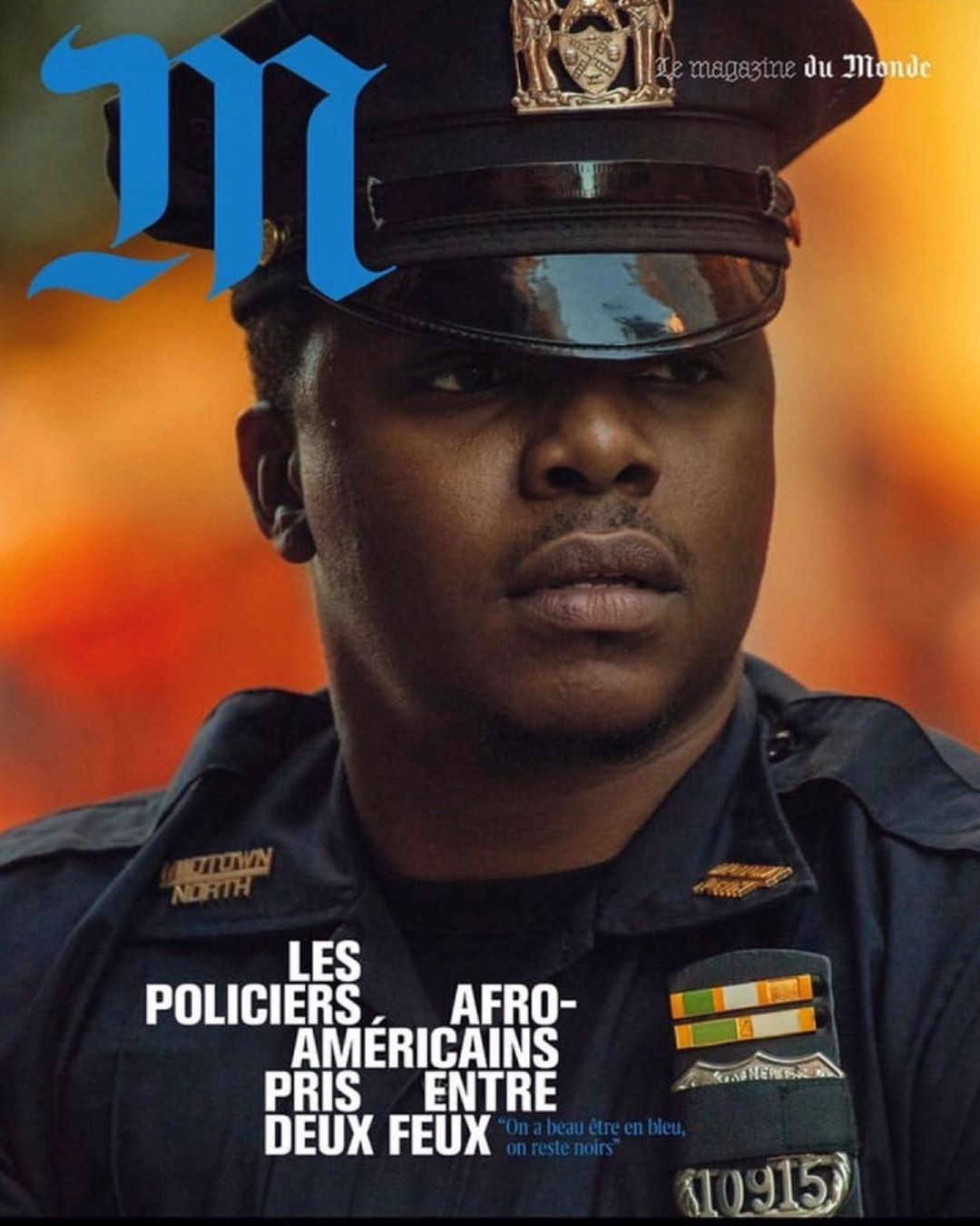 Magazine cover featuring a portrait of an African American police officer in uniform against a blurred orange background.