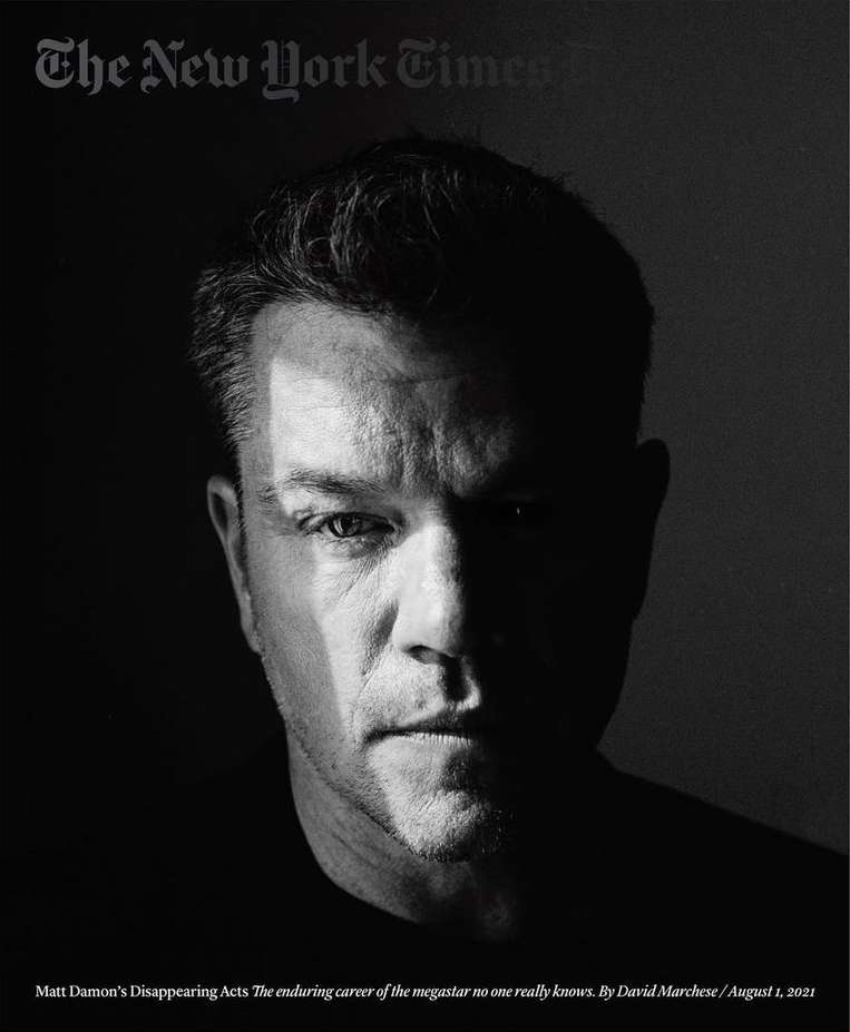 Black and white portrait of Matt Damon for The New York Times, face shadowed, magazine masthead visible, serious expression.