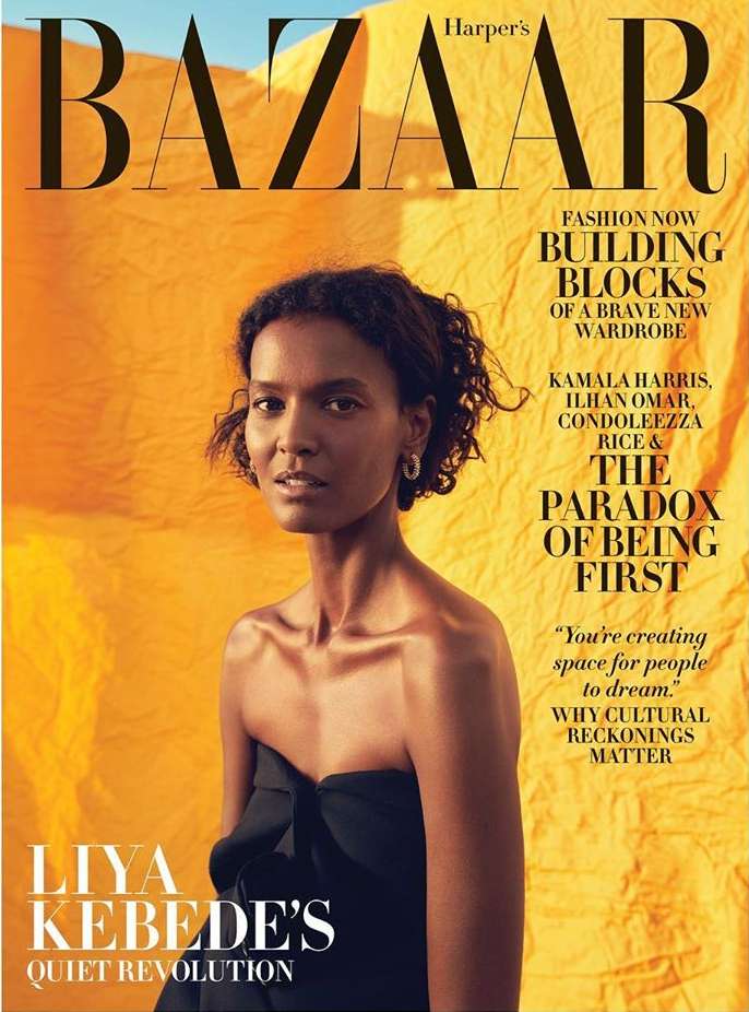 Harper's Bazaar cover featuring model Liya Kebede wearing a black strapless dress against a yellow backdrop, magazine text visible.