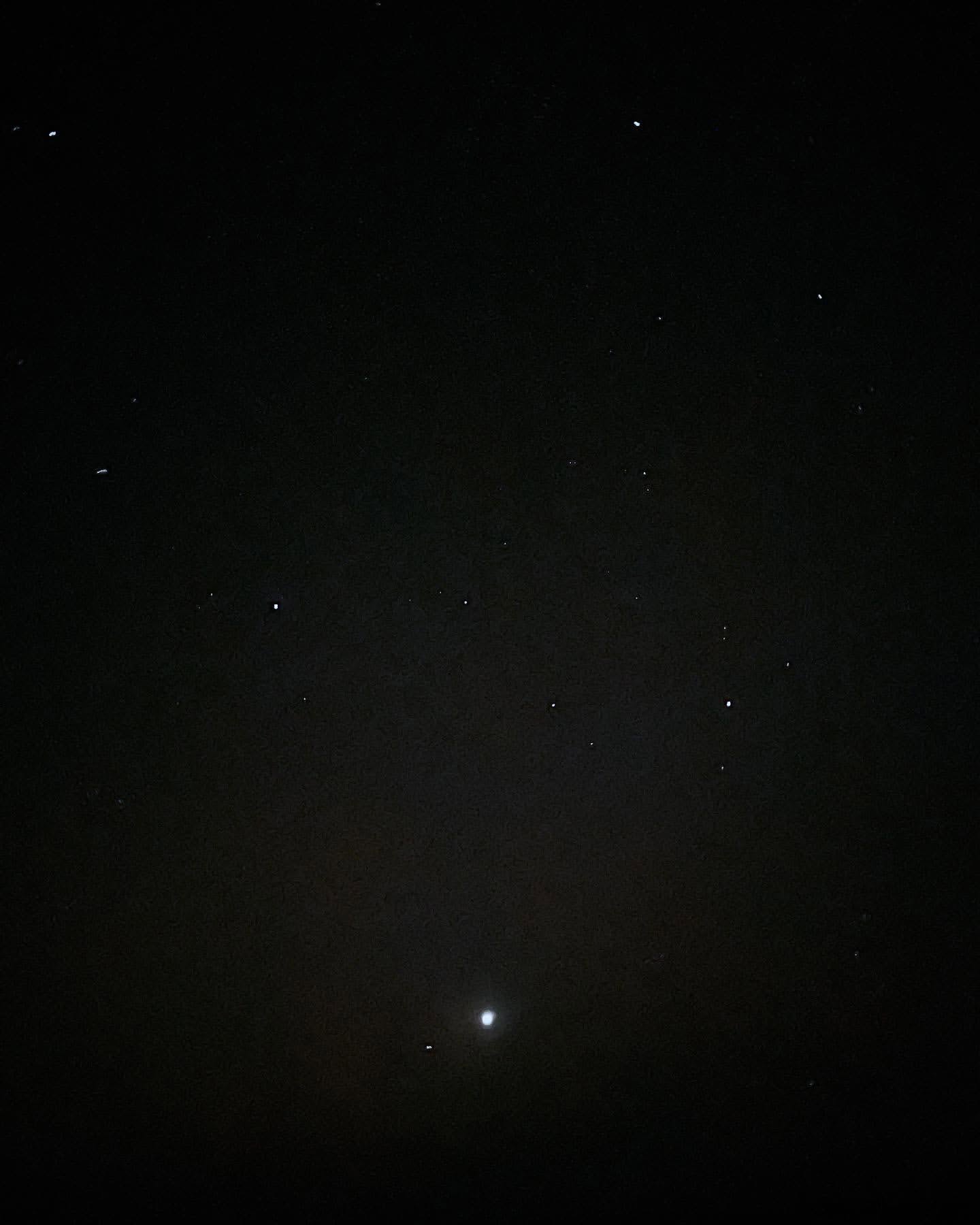 Night sky featuring numerous stars and planets visible against a dark, cloudless backdrop.