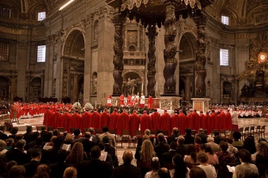 A large religious gathering inside a grand cathedral with cardinals in red robes standing before an ornate altar beneath towering columns.
