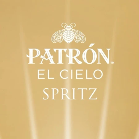 Promotional image for Patron El Cielo Spritz, featuring the brand's logo and product name against a blurred golden background.