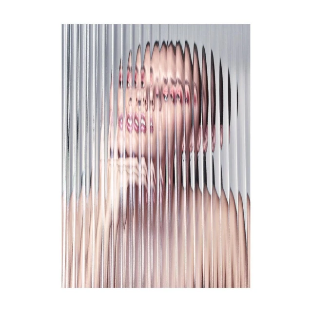 Abstract portrait of a woman behind a clear ribbed screen, featuring pink lips and a blurred skin texture in a vertical composition.