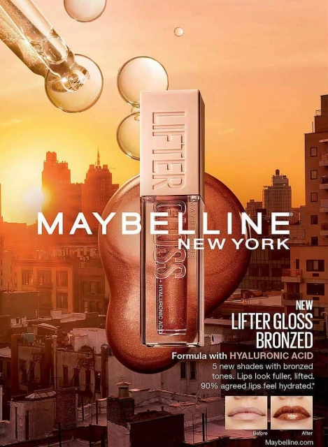 Maybelline Lifter Gloss Bronzed lipstick product shot featuring a glossy liquid texture, set against an urban skyline backdrop.