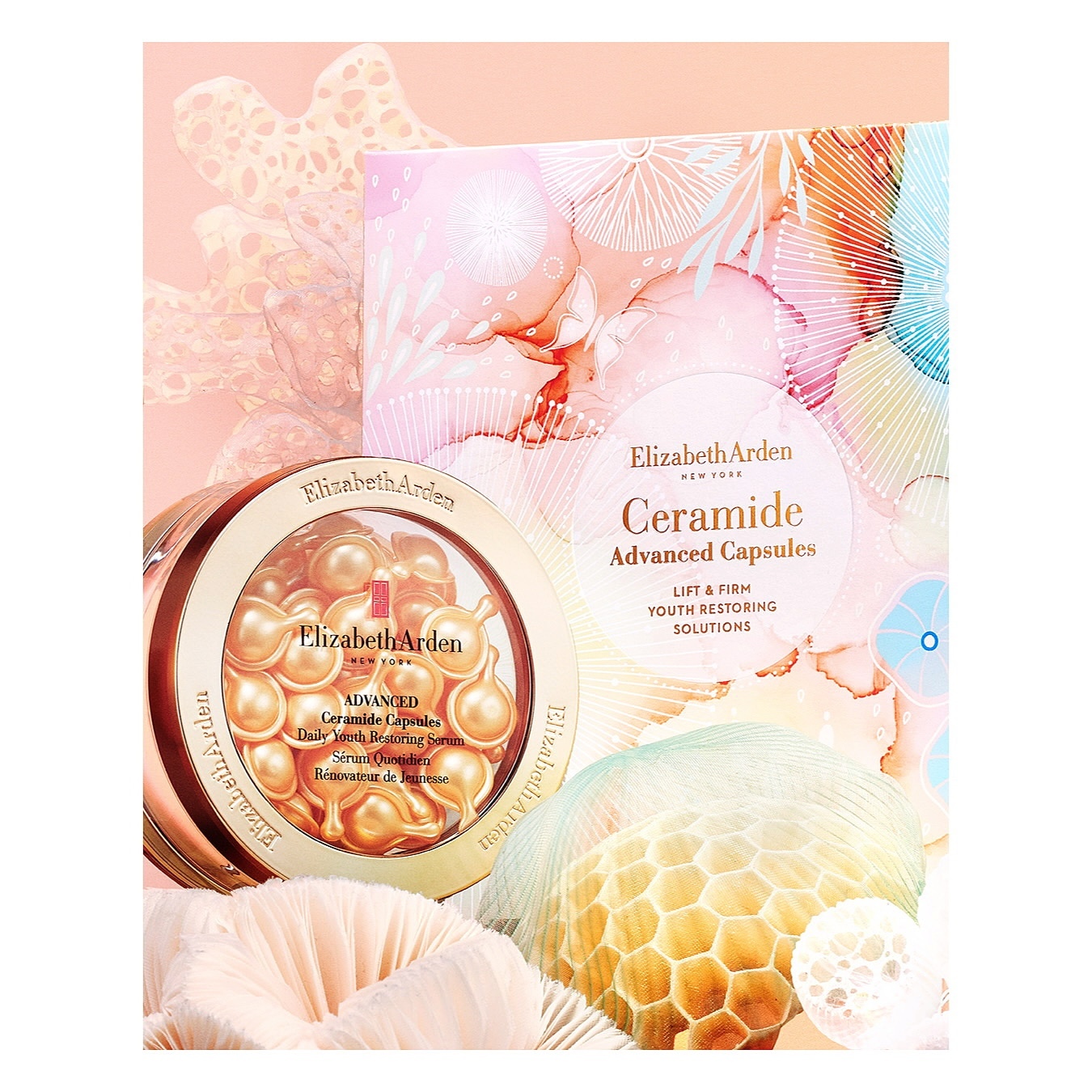 Elizabeth Arden Ceramide Advanced Capsules in gold jar with product box on a peach background with coral-like accents.
