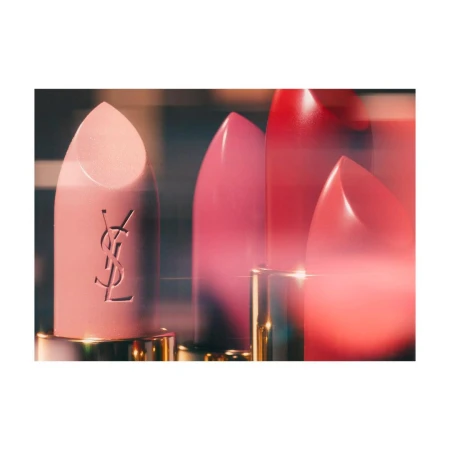 Macro shot of three YSL lipstick tubes in pink, red, and rose, featuring the brand logo, showcasing beauty and fashion.