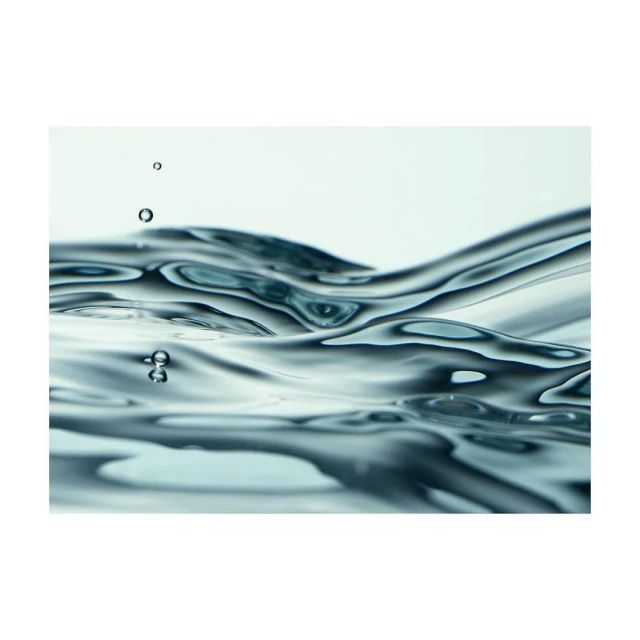 Clear water surface with ripples and small droplets against a light background, highlighting fluid dynamics and minimalist composition.