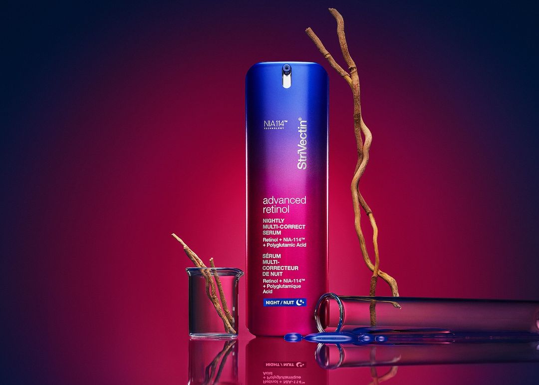 StriVectin advanced retinol nightly multi-correct serum product shot in gradient blue and red background with laboratory glassware and branch.