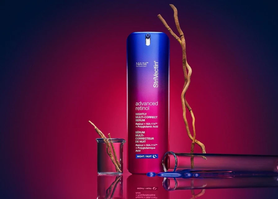 StriVectin advanced retinol nightly multi-correct serum product shot in gradient blue and red background with laboratory glassware and branch.
