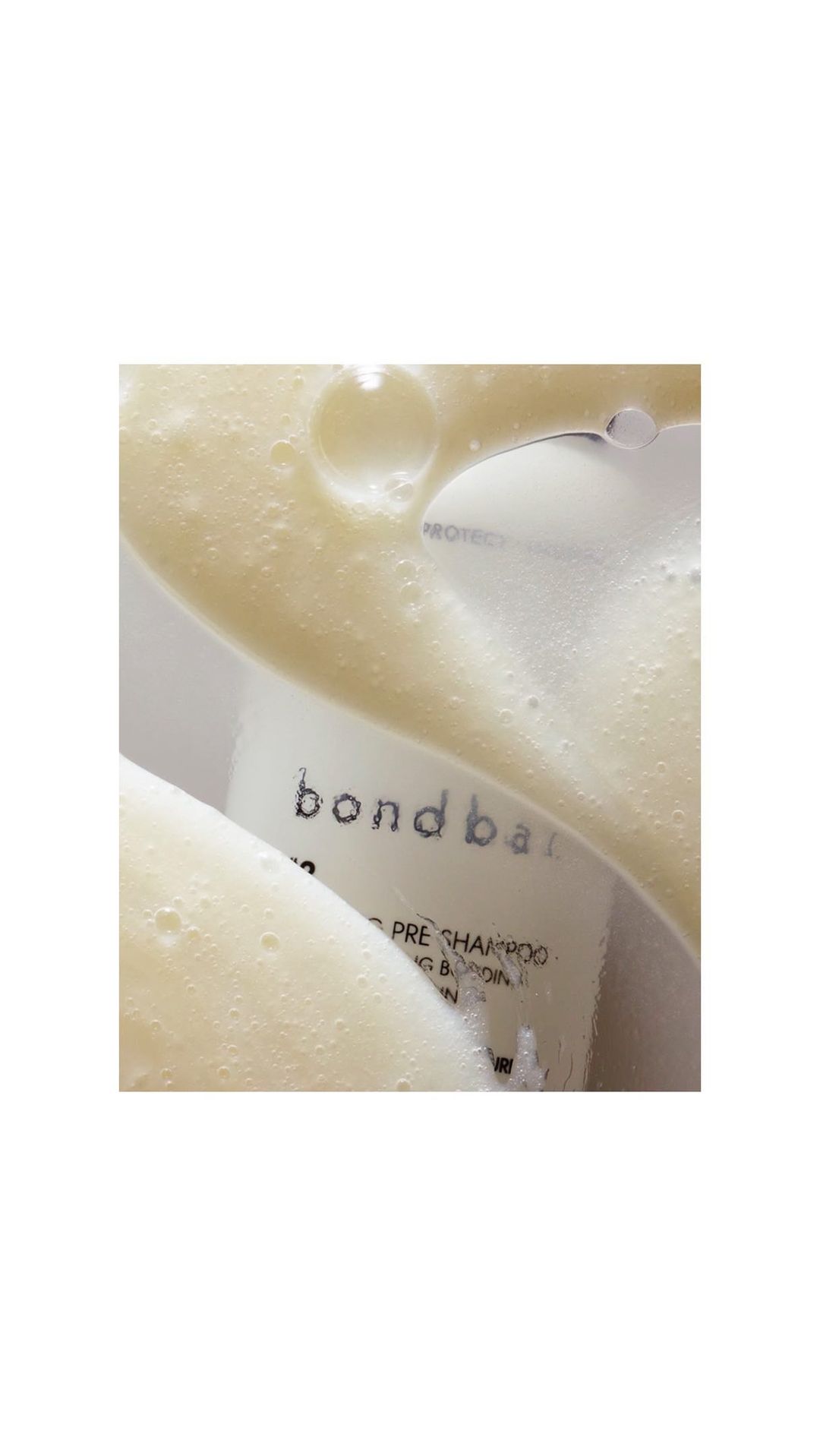 Close-up of Bondbar product with white foamy liquid on top. Beauty product photography. Skin care and hair care advertising.
