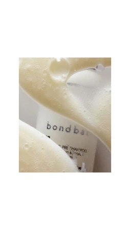 Close-up of Bondbar product with white foamy liquid on top. Beauty product photography. Skin care and hair care advertising.