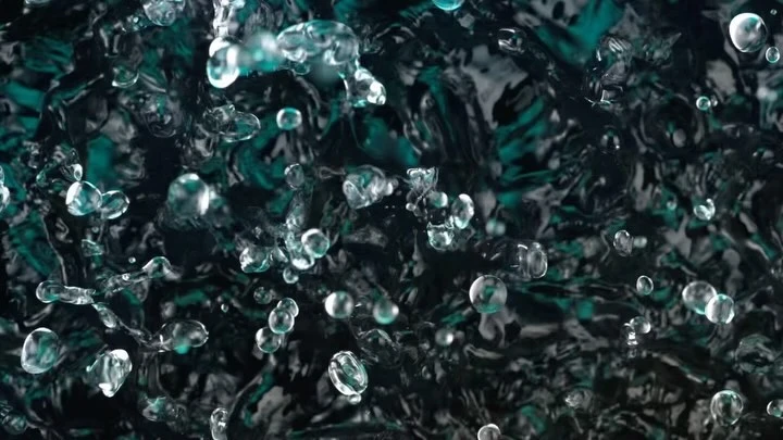 Water droplets suspended mid-air create dynamic abstract art with dark teal and black background. The surface ripples as the droplets fall.
