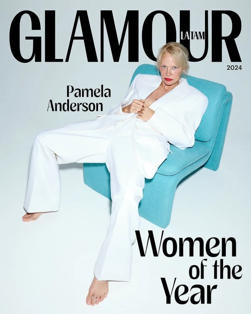 Magazine cover featuring Pamela Anderson in a white suit, seated in a turquoise chair against a clean white background, with 'Glamour' text.