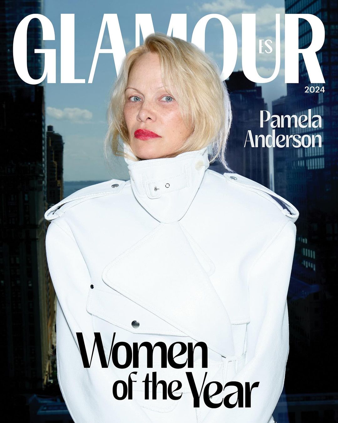 Glamour magazine cover featuring Pamela Anderson, with buildings and a cloudy sky in the background and the magazine's title at the top.