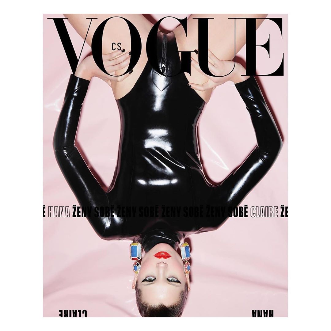 Vogue cover features a person in a black bodysuit, shot upside down against a pink background, with large Vogue masthead on top.