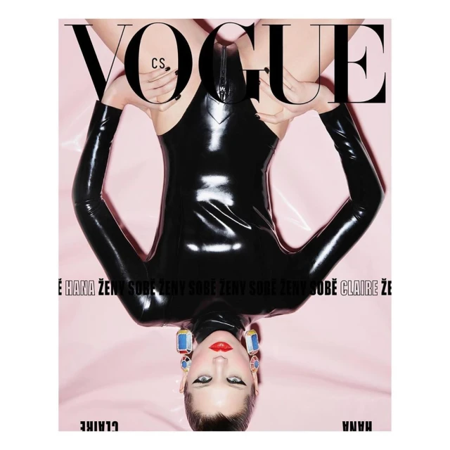Vogue cover features a person in a black bodysuit, shot upside down against a pink background, with large Vogue masthead on top.