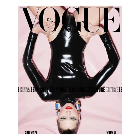 Vogue cover features a person in a black bodysuit, shot upside down against a pink background, with large Vogue masthead on top.