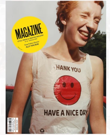 Magazine cover features a smiling woman with red hair, wearing a plastic bag top printed with a smiley face and 'Thank You Have A Nice Day'.