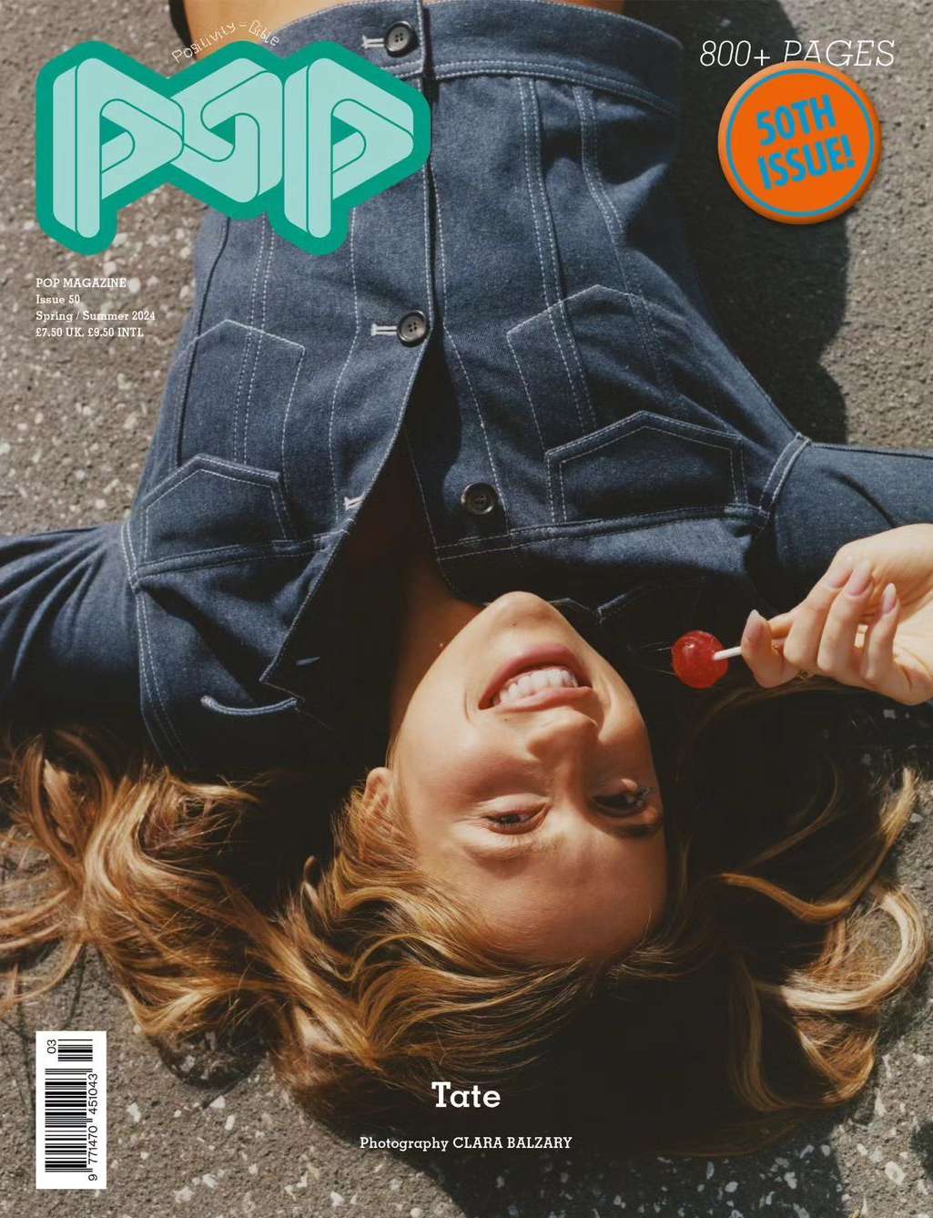 Fashion magazine cover featuring a smiling woman with light brown hair and a denim jacket holding a red lollipop.
