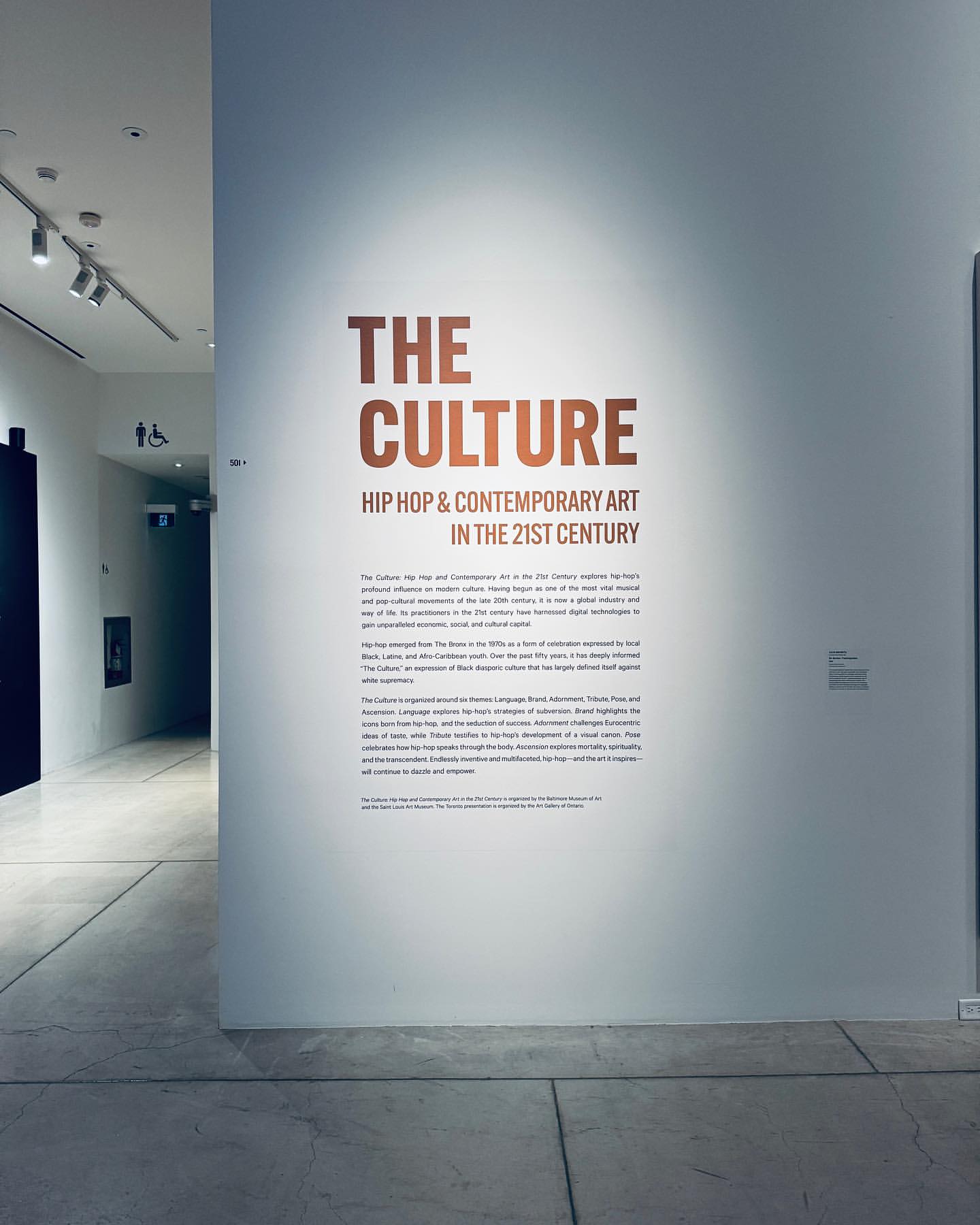 Informational wall display about Hip Hop and Contemporary Art in the 21st Century inside of an art gallery, viewed at eye-level.